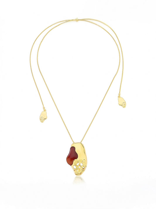 Gold necklace with a unique pendant on a white background