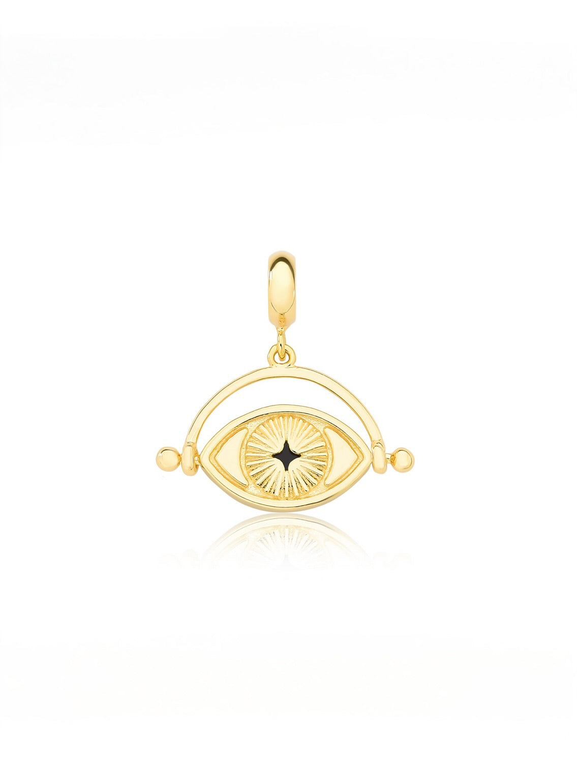 Back side of a gold pendant with eye design on a white background