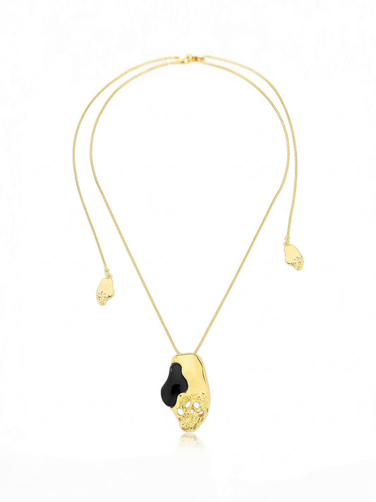 Gold necklace with a black pendant on a white background