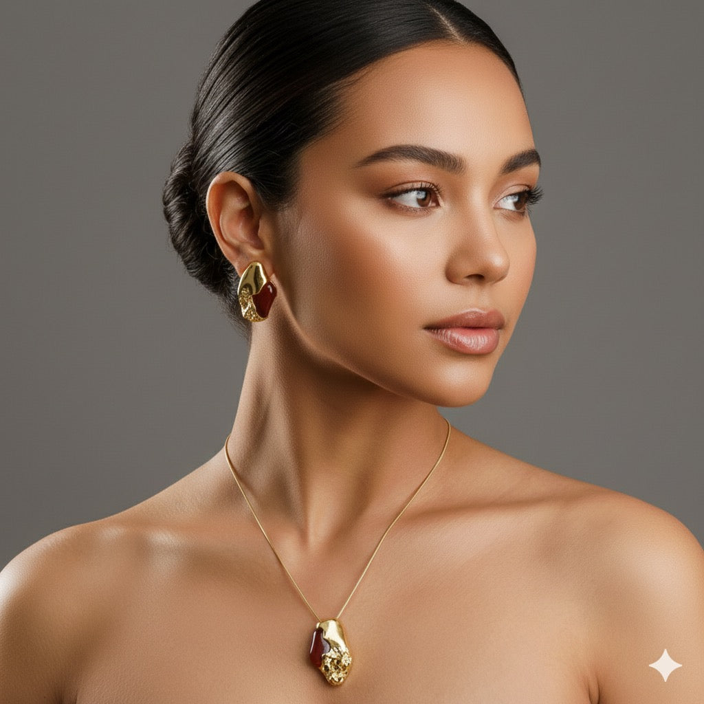 Woman wearing gold jewelry against a gray background