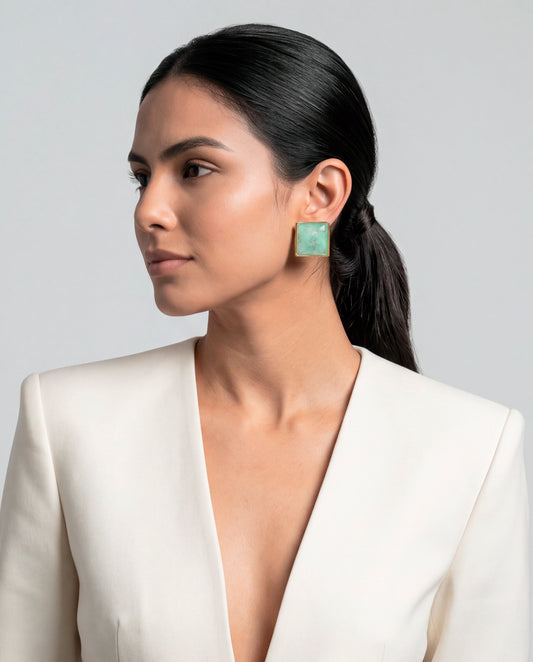 Model wearing  aquamarine stud earrings with 18k gold-plated bezel, Selva Line by Azulique.