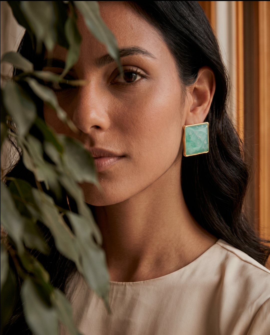 Model wearing  aquamarine stud earrings with 18k gold-plated bezel, Selva Line by Azulique.