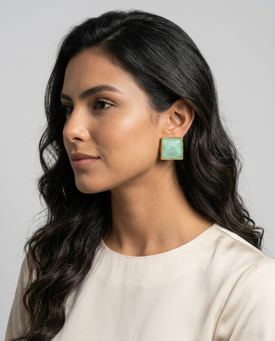 Model wearing  aquamarine stud earrings with 18k gold-plated bezel, Selva Line by Azulique.
