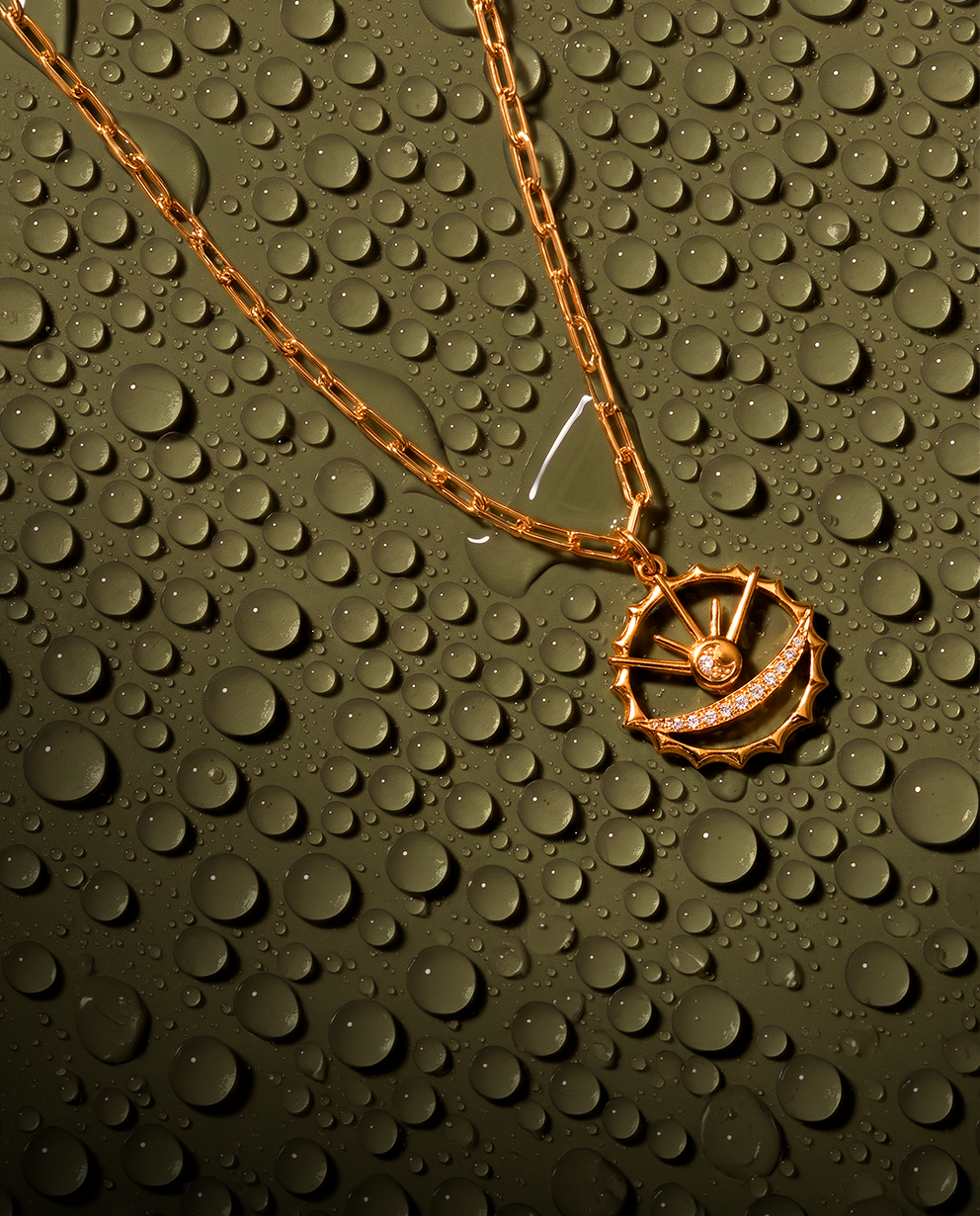 Woman wearing chain earrings with 18k gold-plated finish and Crystal gold pendant necklace with 18k gold-plated finish, Azulique Line by Azulique.