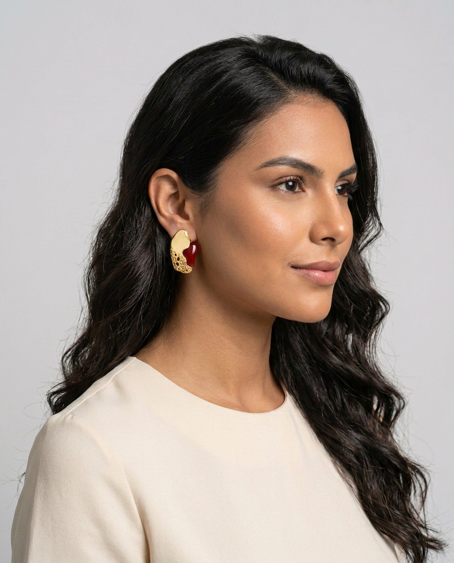 woman wearing a Crimson red agate and textured gold Luxor statement stud earrings.