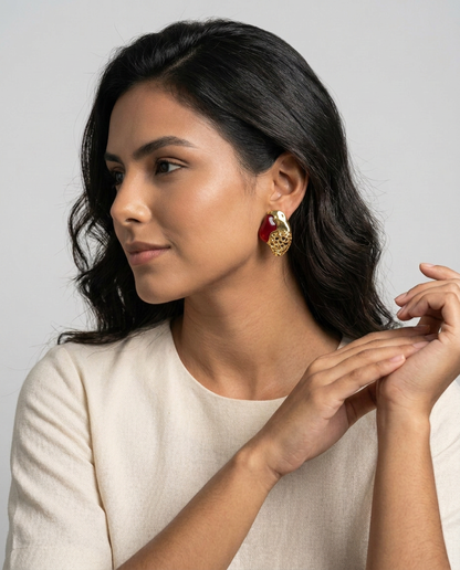 woman wearing a Crimson red agate and textured gold Luxor statement stud earrings.