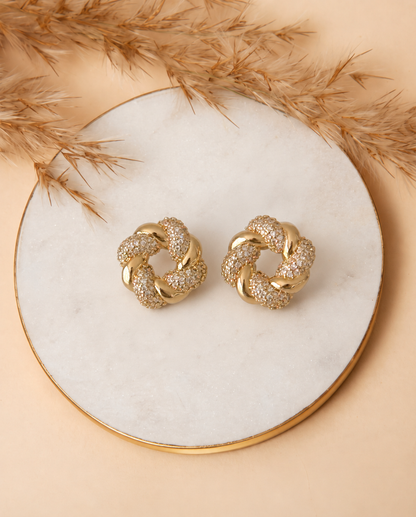 Close-up of the woven pattern and cut crystals on the Croissant Earrings.