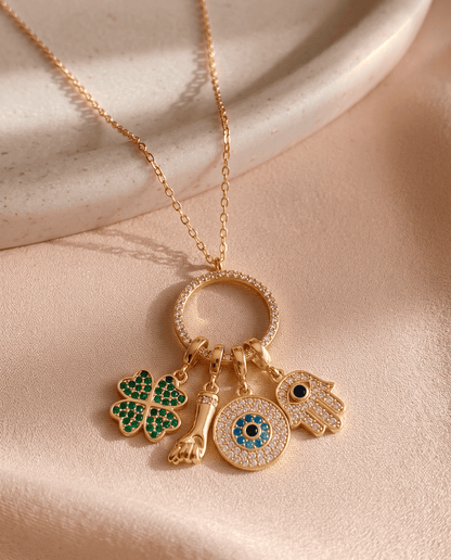 Gold plated Sorte lucky charm necklace with cubic zirconia figa, four leaf clover, evil eye and hamsa charms.