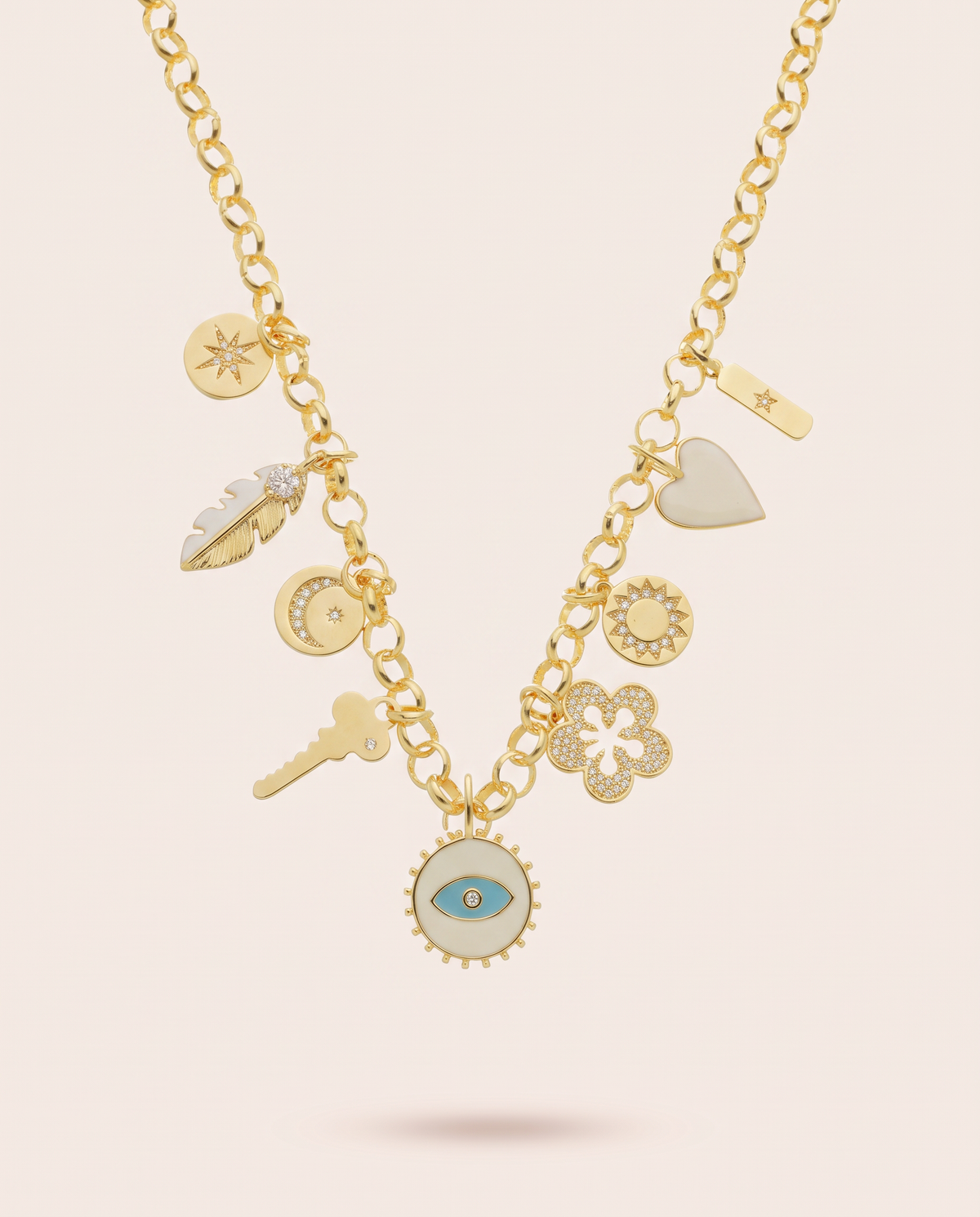 Azulique Divinity charm necklace with a gold finish, celestial medallions and a central cream pendant featuring a blue evil eye.