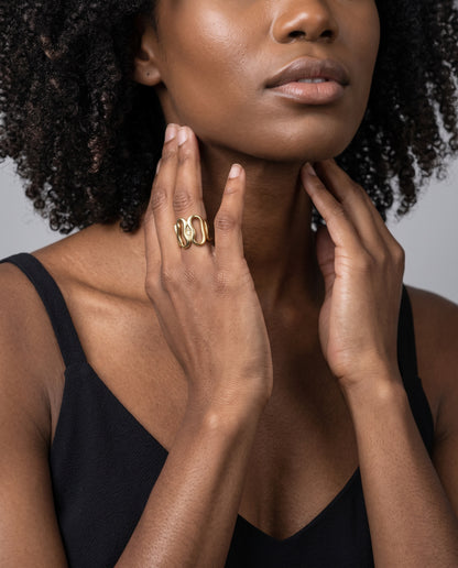 Gold wide openwork statement ring with curved loops and pavé crystal details worn