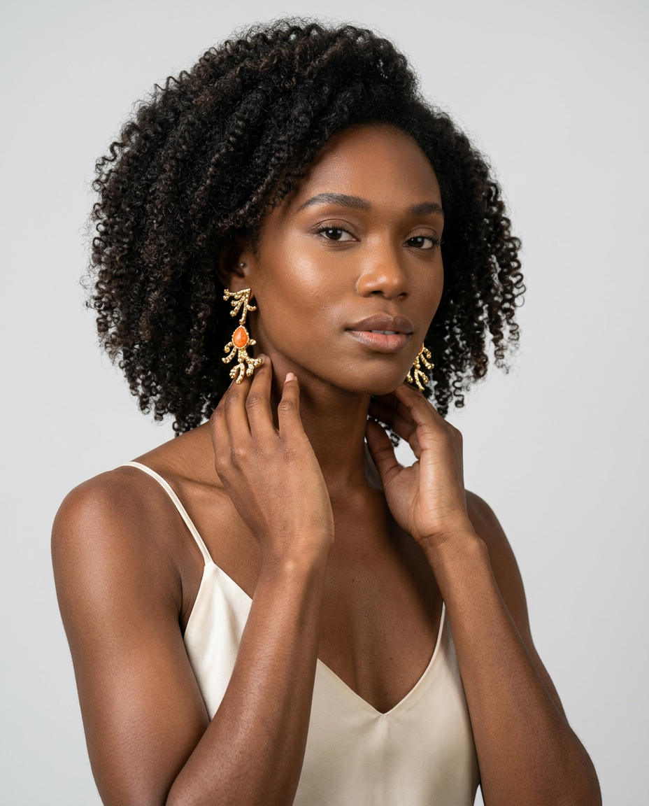 Model wearing orange calcite sculptural earrings with 18k gold-plated finish, Selva Line by Azulique.