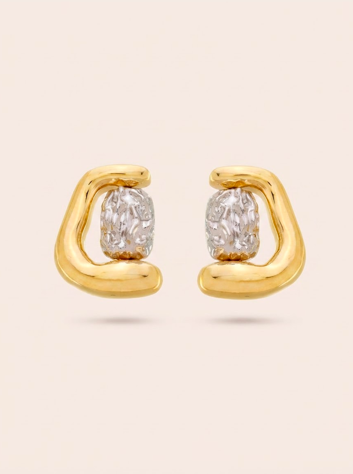 Obsydian two-tone statement earrings with a rounded gold finish and textured silver-tone center.